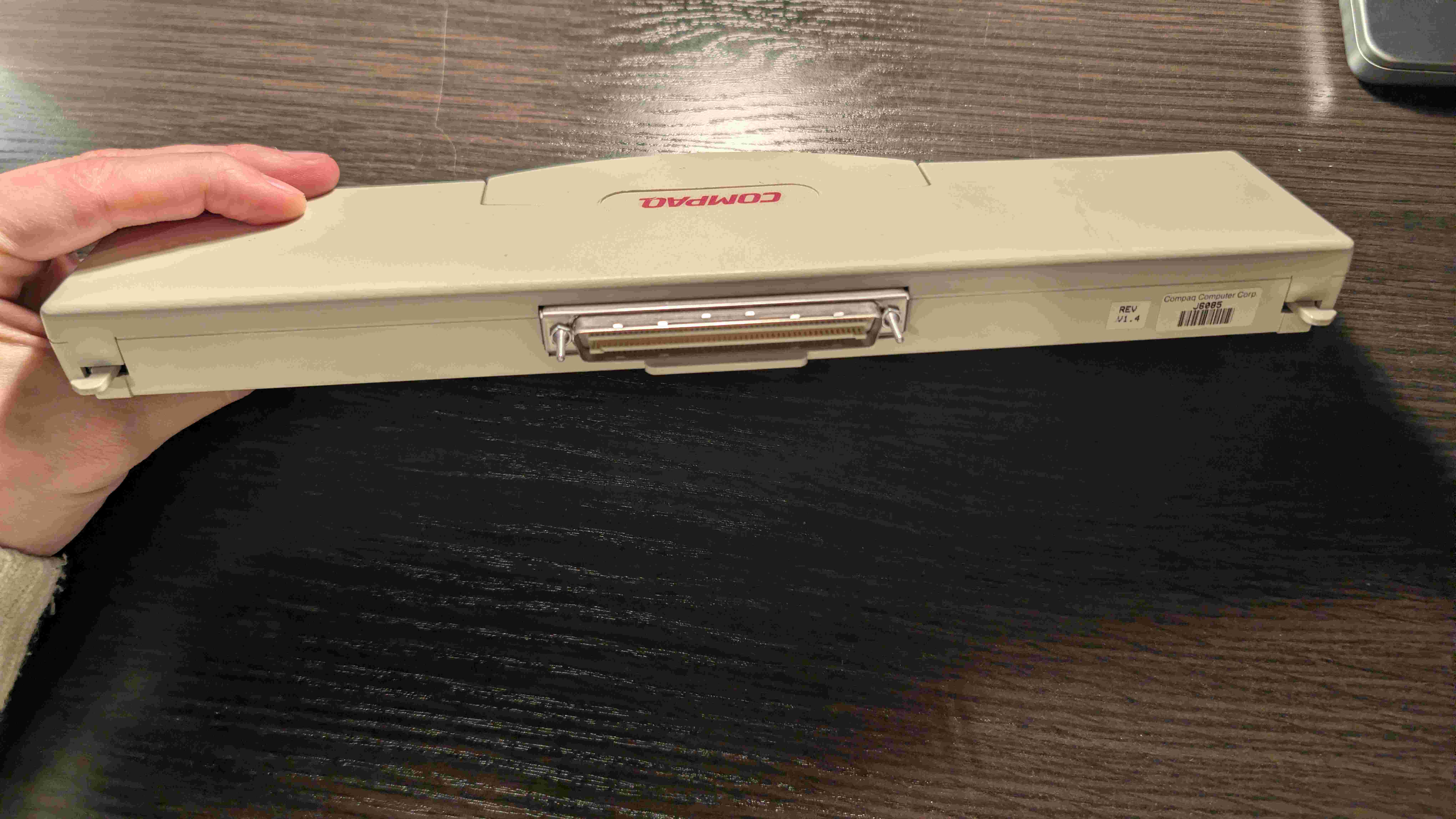 Angled view of the Compaq MPEG TV Video adapter showing its black housing and connector