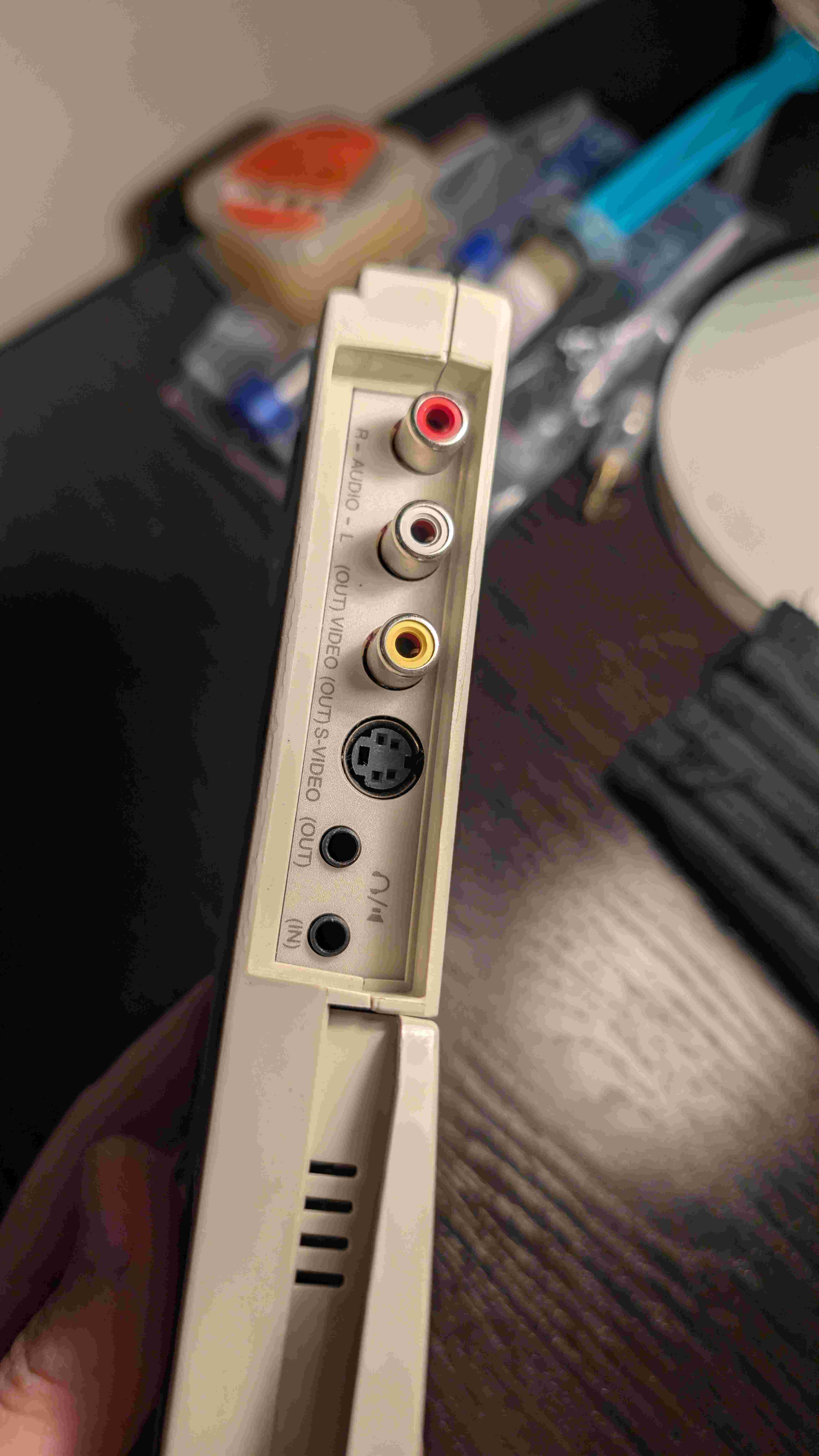 Rear panel of the adapter showing composite, S-Video output ports and audio jacks on the left side