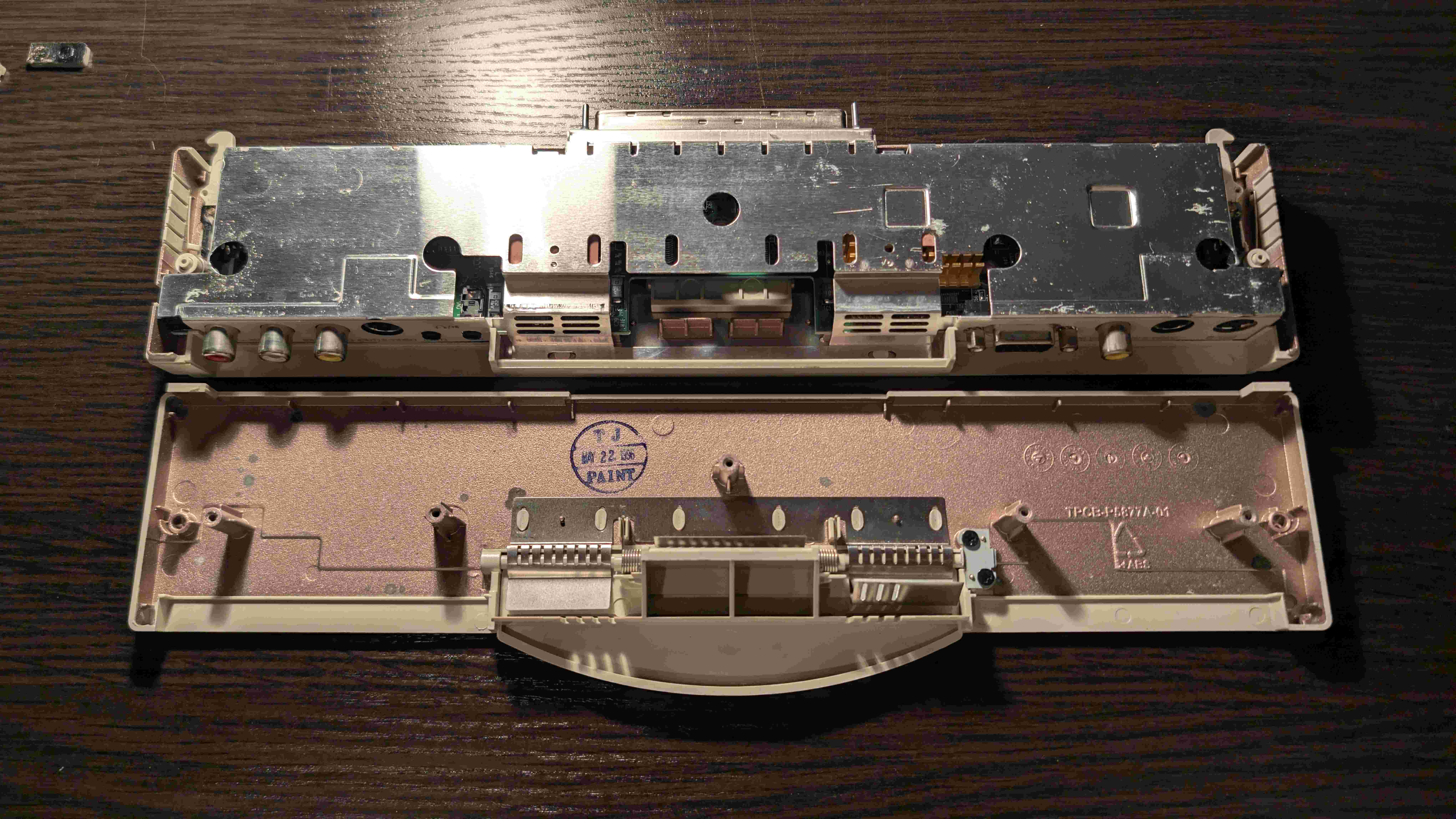 Disassembled Compaq adapter showing the opened case with manufacture date visible