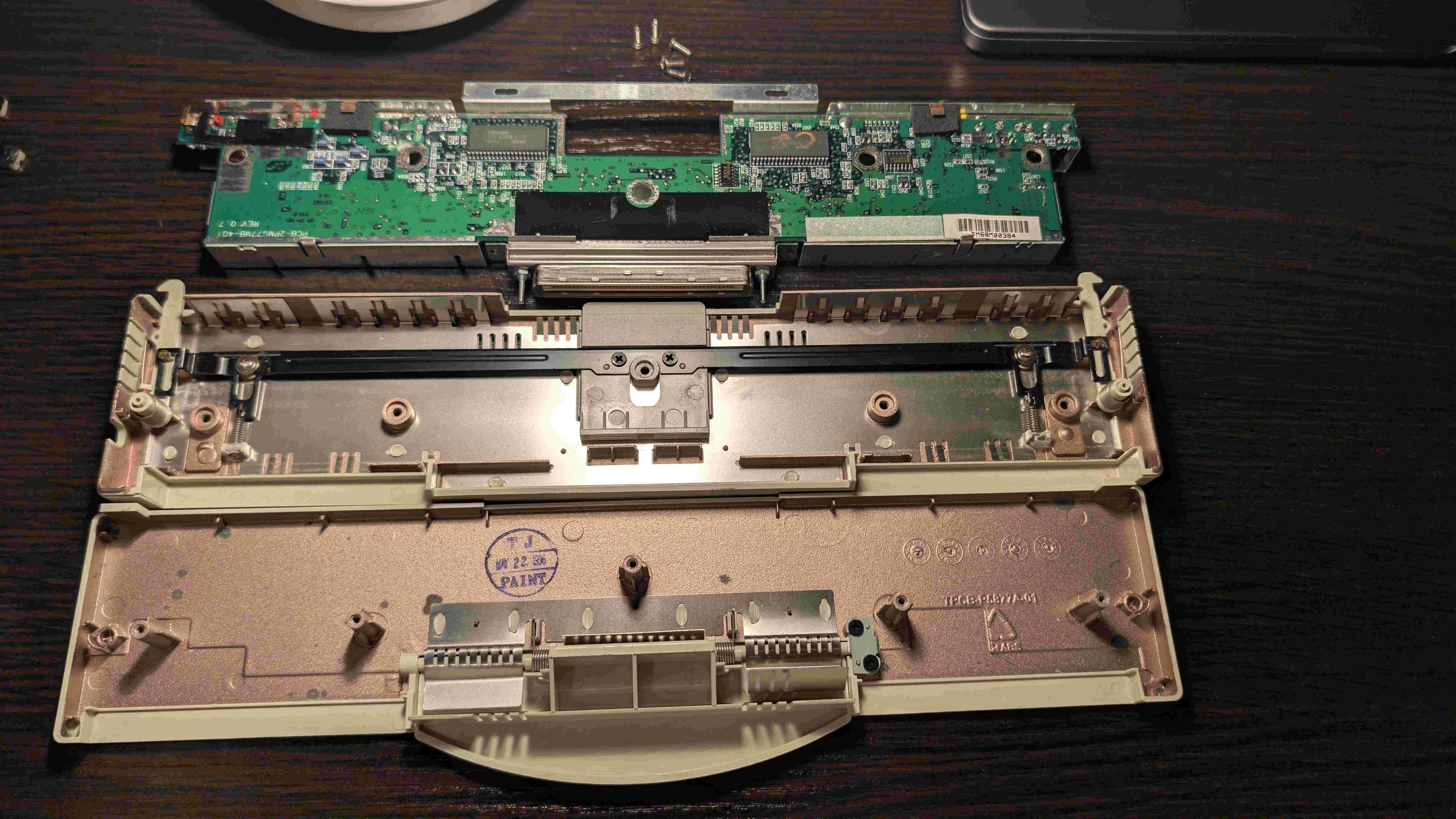 Disassembled Compaq adapter showing the opened case PCB